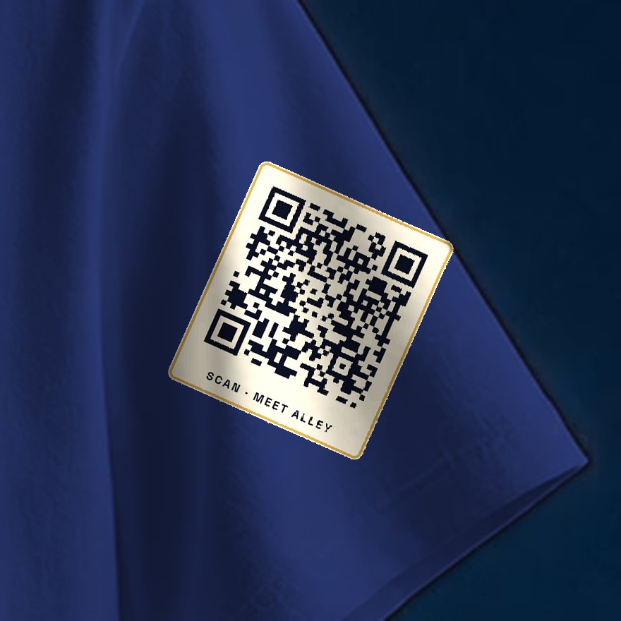 Close-up of the small Saturday QR code printed on the tee. It opens saturdayforthewin.com/scan.html.