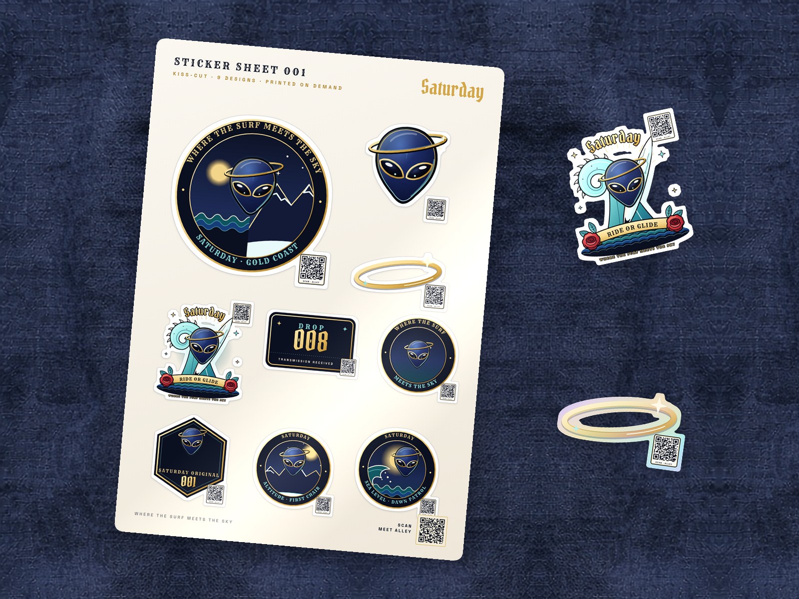 Saturday Sticker Sheet 001 on navy linen: nine kiss-cut stickers with a small QR in the corner